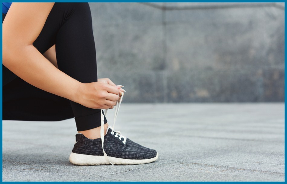 A woman wear allbirds alternative shoes & tying shoelaces before running