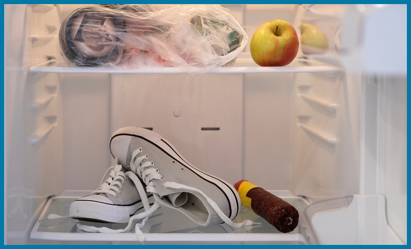 A pair of shoes is kept inside the fridge to remove the wax